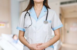 woman in white button up shirt and blue stethoscope