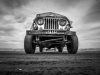 a black and white photo of an old jeep