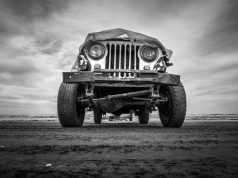 a black and white photo of an old jeep