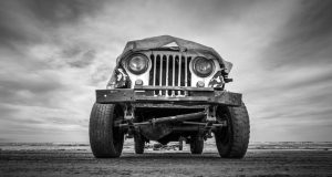 a black and white photo of an old jeep