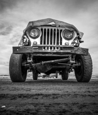 a black and white photo of an old jeep