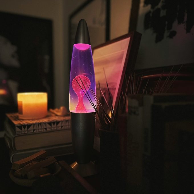 a purple lamp sitting on top of a table