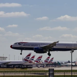 Heathrow Airport expansion construction plans with financial document showing £320 million cost recovery approval