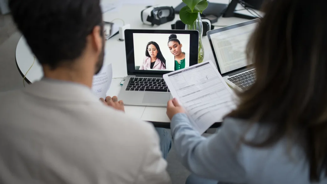Young professional participant in a virtual job interview on computer screen, highlighting challenges of remote hiring processes
