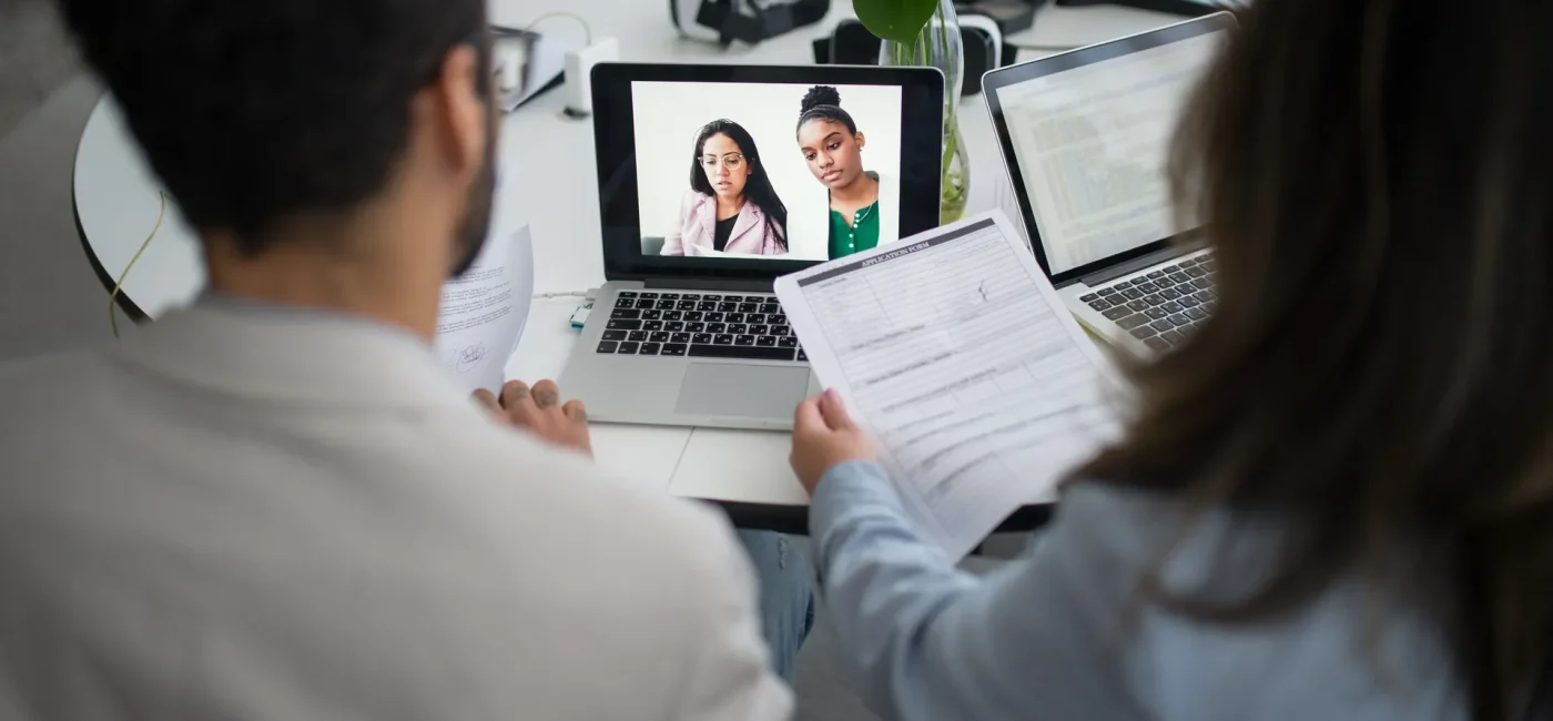 Young professional participant in a virtual job interview on computer screen, highlighting challenges of remote hiring processes