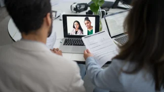 Young professional participant in a virtual job interview on computer screen, highlighting challenges of remote hiring processes