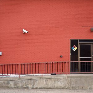 Security camera and rear entrance on a commercial building: Business Crime Outlook: Almost One UK Firm in Three Likely to Suffer an Offence Over the Current Year