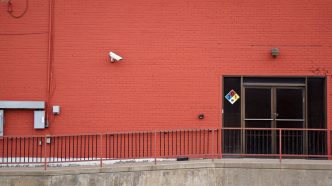 Security camera and rear entrance on a commercial building: Business Crime Outlook: Almost One UK Firm in Three Likely to Suffer an Offence Over the Current Year