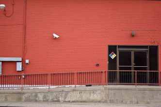 Security camera and rear entrance on a commercial building: Business Crime Outlook: Almost One UK Firm in Three Likely to Suffer an Offence Over the Current Year