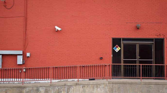 Security camera and rear entrance on a commercial building: Business Crime Outlook: Almost One UK Firm in Three Likely to Suffer an Offence Over the Current Year