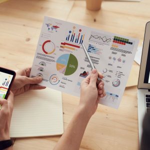 Proven Category Knowledge Is What Divides Great Agencies From Merely Adequate Ones: marketing specialists reviewing SEO and campaign analytics charts at a desk