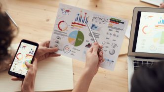 Proven Category Knowledge Is What Divides Great Agencies From Merely Adequate Ones: marketing specialists reviewing SEO and campaign analytics charts at a desk