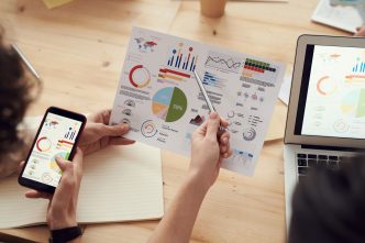 Proven Category Knowledge Is What Divides Great Agencies From Merely Adequate Ones: marketing specialists reviewing SEO and campaign analytics charts at a desk