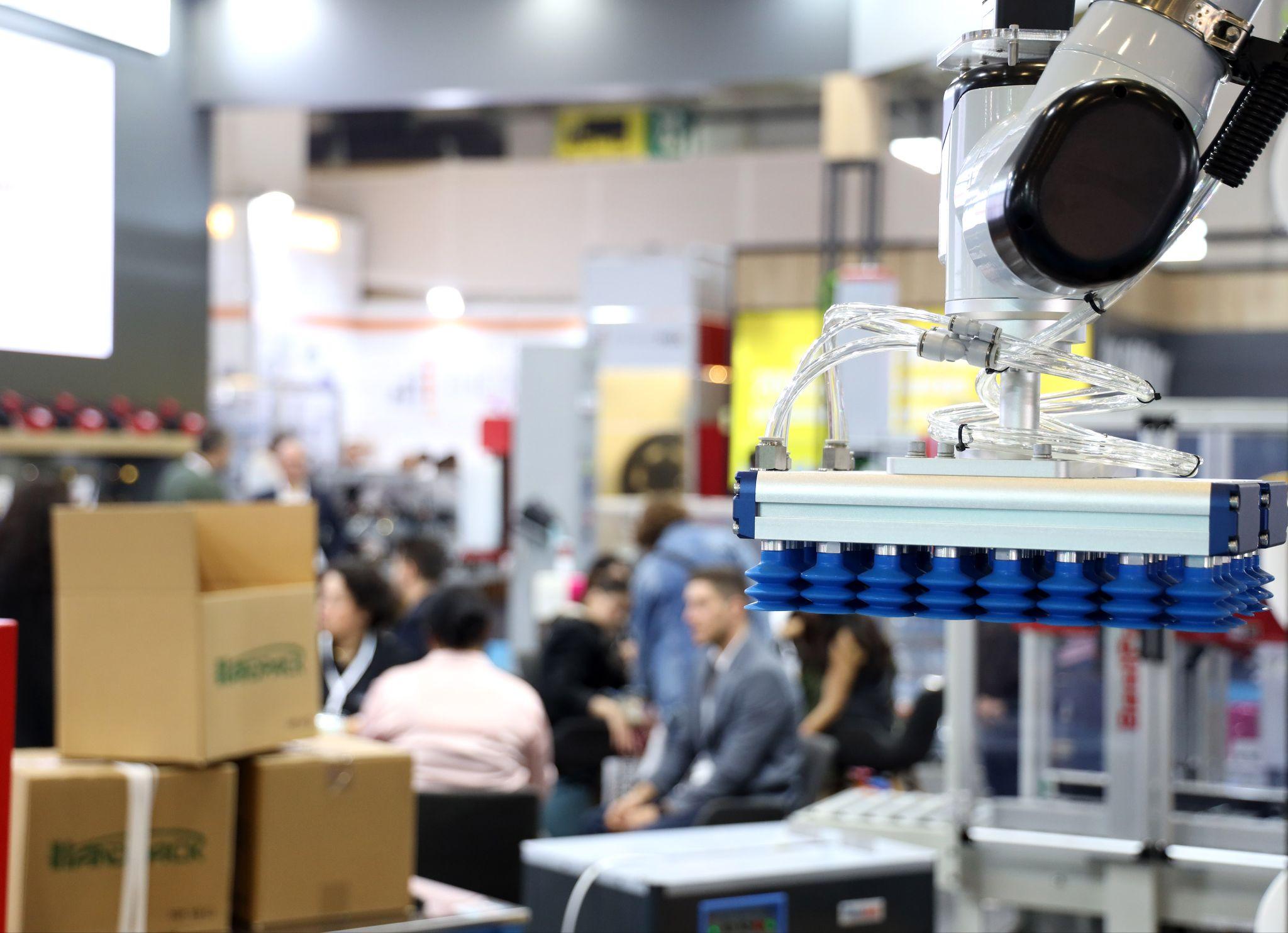 Reed Tüyap brings the packaging industry together in Istanbul next October: a robotic vacuum gripper lifting cartons on an exhibitor stand at Eurasia Packaging Istanbul